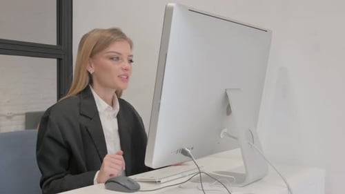 Business Woman Doing Online Video Chat on Desktop in Office