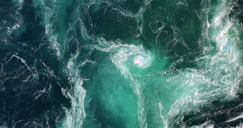 Blue waves of water of the river and the sea meet each other during high tide and low tide.
