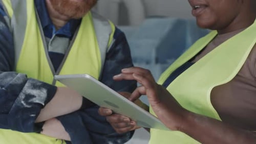 Factory Workers Using Digital Tablet