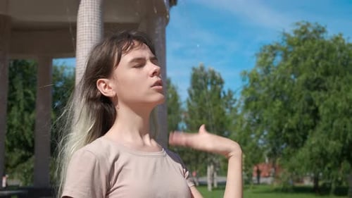 Woman Cooling off in City Fountain on Hot Day