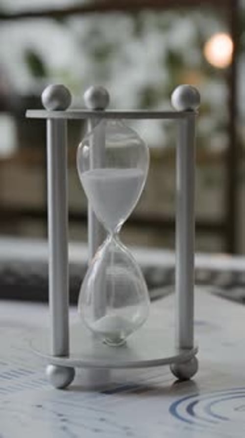 Silver Hourglass On Graph Paper Stack