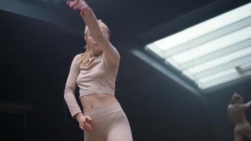 Young Woman Dance in a Mirror Studio Room Flexible Woman Performs a Stretching Dance with Yoga