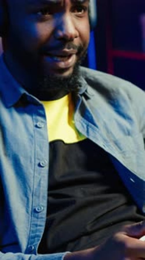 Focused Man Playing Video Game with Headphones