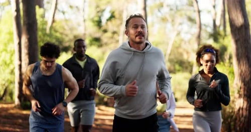 Man, group and trail running in forest for exercise, challenge and training with cardio in summer