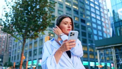 Closeup View of Lovely Young Caucasian Woman Using Smartphone Online Looking at Camera Smiling
