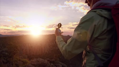 Medium Shot Of A Young Independent Female Hiker With Red Backpack And Green Jacket Navigating Wit...