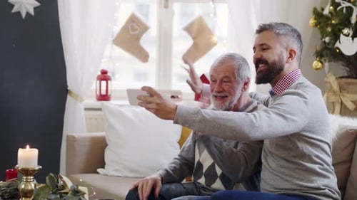 Man and Senior Video Calling at Christmas time