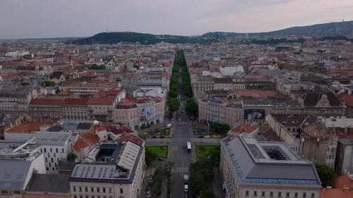 Fly Above Buildings and Streets in Large City Vehicles Passing Through Crossroads in Urban Borough