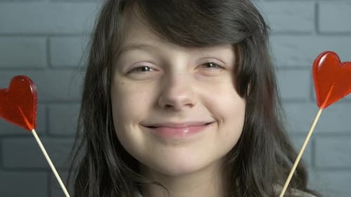 Smiling Girl with Heart Lollipop Candy