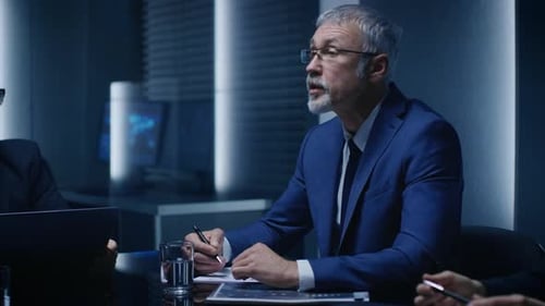 Men in suits have corporate meeting at table