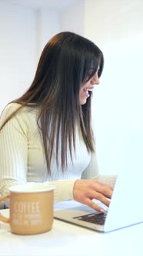 Businesswoman working with a computer sitting at home, business via home office, telecommuting