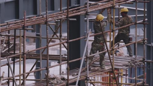 Construction Workers on Scaffolding at an Urban Building Site