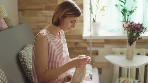 Woman Knitting at Home in Casual Setting