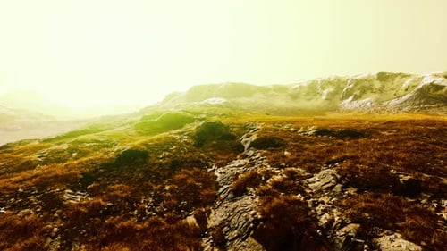 A Breathtaking Mountain Landscape with Lush Green Grass and Rugged Rocks