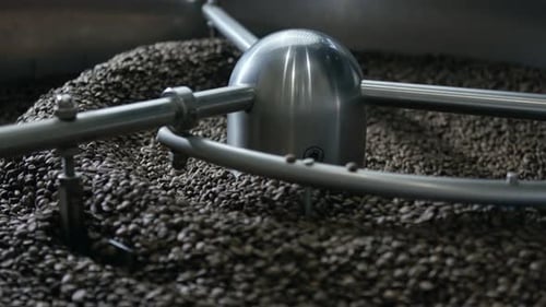 Machine Roasting Coffee Beans in Factory Setting