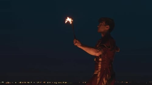 Fire Breather Performing Nighttime Stunt with Flames