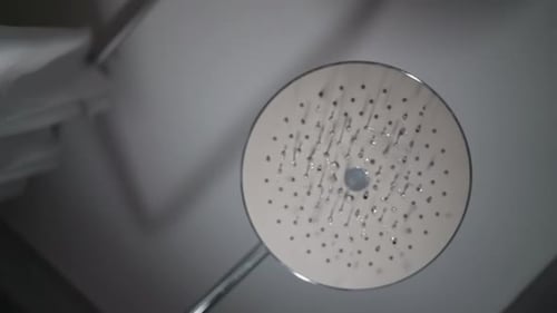 Water Flowing From Modern Shower Head Close Up