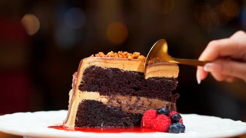 woman eat slice of Chocolate cake in slow motion blurry background restaurant