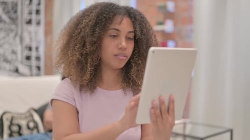 Woman Using Tablet in Living Room