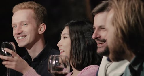 Friends Together Drinking Wine and Socializing Indoors