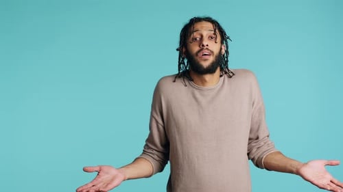 Uncaring Man Shrugging Shoulders Showing Indifference Studio Background