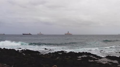 Time-lapse day to night at sea were on the horizon anchored in the open sea large fish processing bo