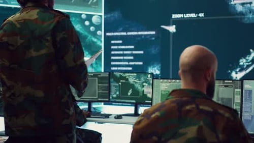 People in Camouflage Working at Computers in Modern Office