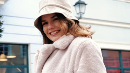 Young Woman Smiling in Fuzzy Coat and Hat