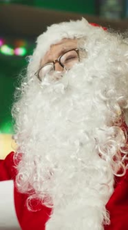 Vertical Video Santa Claus Falling Asleep While Reading Christmas Letters From Kids
