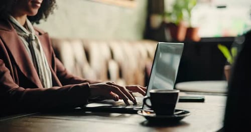 Hands, woman and typing on laptop at cafe for remote work, writing story and email feedback