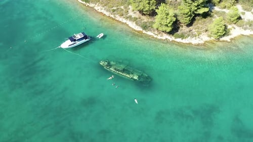 Yacht Float On Blue Water Next To Shipwreck Sank In The Sea In Solta, Croatia. - aerial