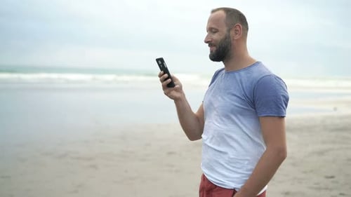 Man Texting on Beach Summer Getaway