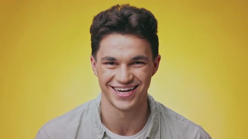 Smiling Young Man Portrait on Bright Yellow Background