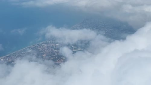 Aerial View Mountain Peaks Shrouded in Clouds With Green Forests and Expansive Fields