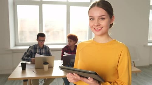 Portrait of Female Team Leader Businesswoman Standing in Office with Colleagues Meeting in