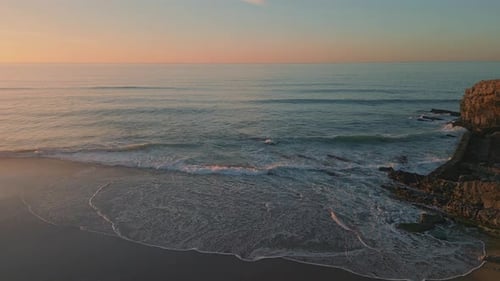 Pastel Sunrise Splashing Ocean Aerial View Foamy Waves Washing Stoned Seashore