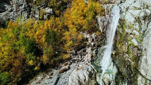 Amazing Small Waterfall In Cliff Of High Mountain With Forest On Slope Aerial Shot Water Falling On