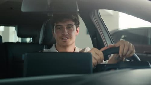 Man Smiling Inside of a Car