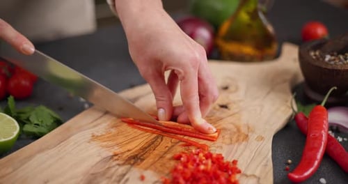Slicing a Red Chili Pepper on Cutting Board