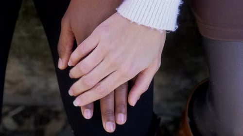 Two People Holding Hands with Tenderness and Love