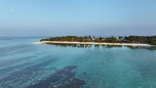 Aerial view of lush tropical island and ocean, Maldives.