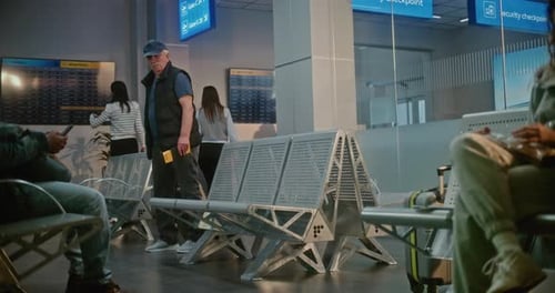 Airport Terminal Senior Man with Suitcase Documents and Boarding Pass Sitting in Departure Lounge