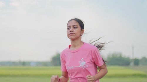 Young lady jogging on the road in the morning.