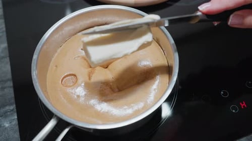 Margarine Melting Into Steaming Food on Electric Stove