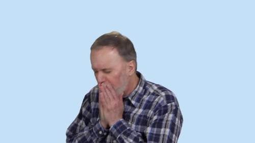 Man Coughing into Hands