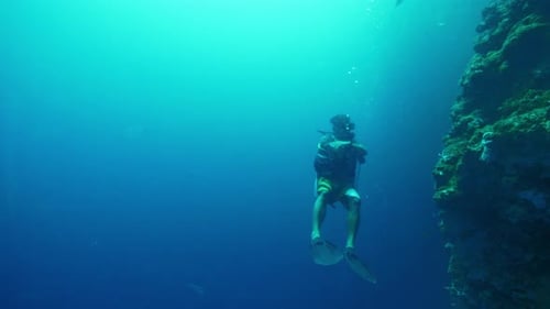 Diver Clad in Hightech Suit Glides Through Underwater World