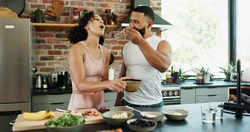 Smiling Couple Prepares Healthy Food Together in Kitchen