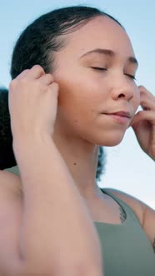 Fitness, thinking and woman with earphones in city for exercise, workout and training with music