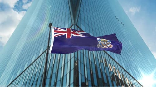 Waving Flag in Front of Modern Skyscraper