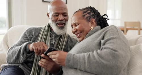 Senior Couple Smiling Together at Mobile Phone